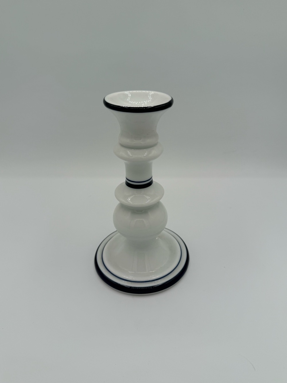 White ceramic Dansk Bistro taper candle holder with blue and black banding.